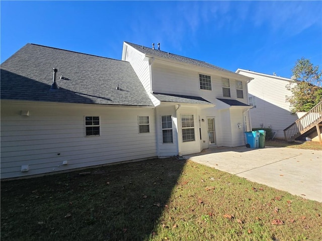 back of property featuring a yard and a patio