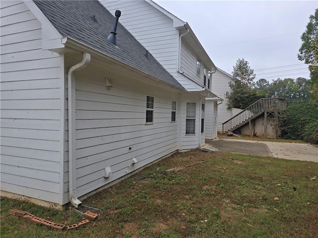 view of home's exterior featuring a patio and a yard