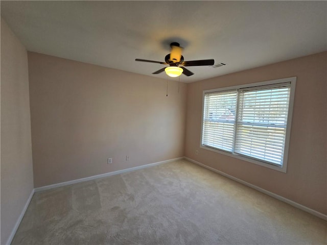 spare room with light carpet and ceiling fan