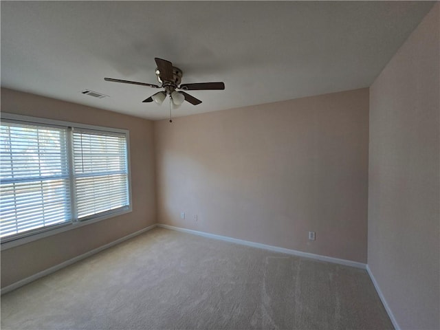 empty room with light carpet and ceiling fan