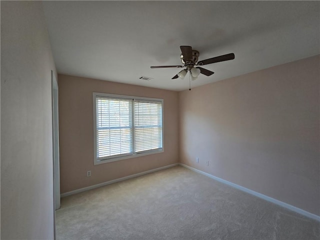 carpeted spare room with ceiling fan