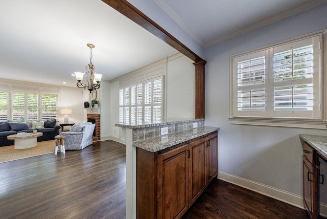 2668 Jefferson Ter, East Point, GA 30344 - kitchen featuring baseboards, dark wood-style floors, a chandelier, ornamental molding, and a peninsula