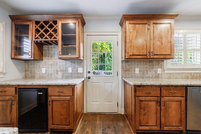 2668 Jefferson Ter, East Point, GA 30344 - kitchen with beverage cooler, dark wood finished floors, ornamental molding, plenty of natural light, and brown cabinets