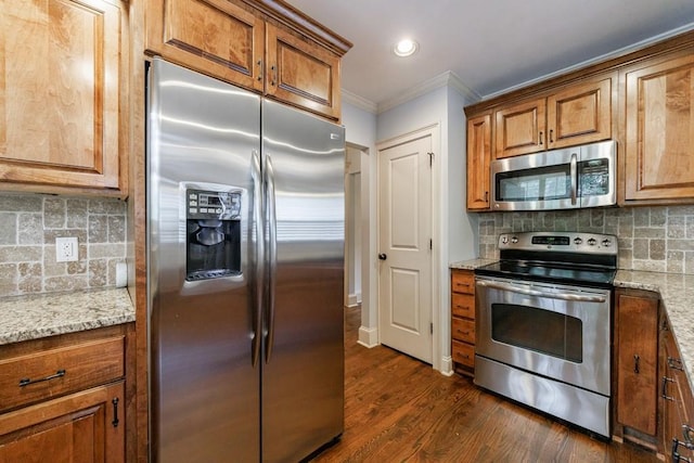 2668 Jefferson Ter, East Point, GA 30344 - kitchen featuring appliances with stainless steel finishes, crown molding, brown cabinetry, backsplash, and dark wood-type flooring
