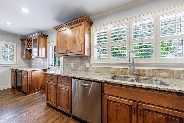 2668 Jefferson Ter, East Point, GA 30344 - kitchen featuring a sink, dishwasher, ornamental molding, brown cabinets, and light stone counters