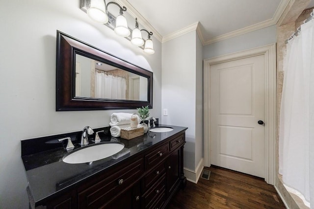 2668 Jefferson Ter, East Point, GA 30344 - full bathroom featuring crown molding, wood finished floors, and double vanity