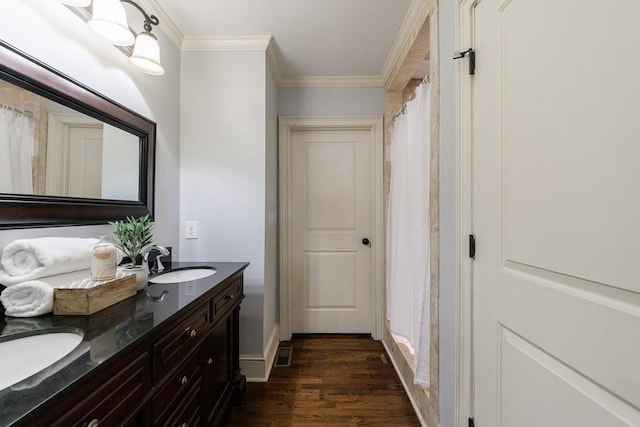 2668 Jefferson Ter, East Point, GA 30344 - bathroom with wood finished floors, ornamental molding, double vanity, and baseboards