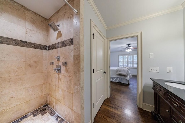 2668 Jefferson Ter, East Point, GA 30344 - bathroom with a tile shower, ornamental molding, wood finished floors, vanity, and ensuite bath