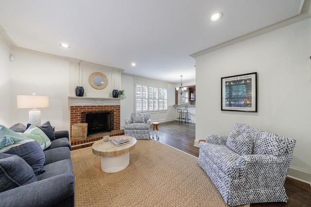 2668 Jefferson Ter, East Point, GA 30344 - living area featuring crown molding, dark wood finished floors, baseboards, a chandelier, and a brick fireplace