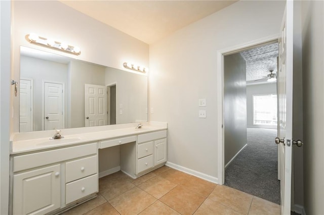 bathroom featuring tile patterned floors, ceiling fan, and vanity