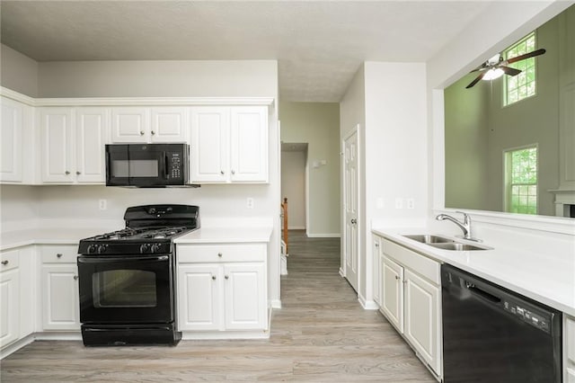 kitchen featuring ceiling fan, white cabinets, sink, light hardwood / wood-style flooring, and black appliances