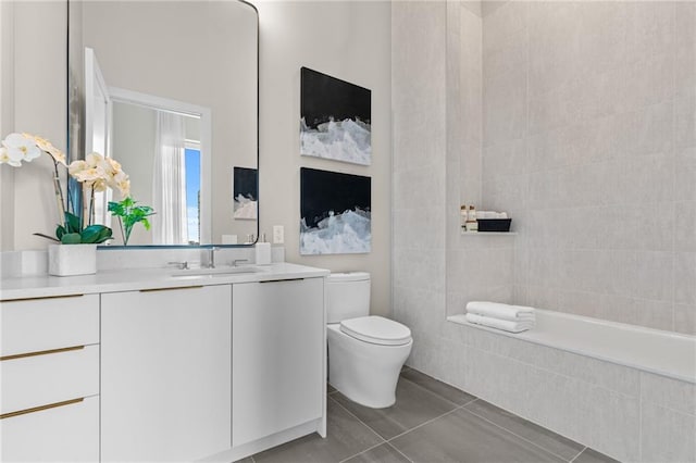 bathroom with vanity, toilet, and tile patterned flooring