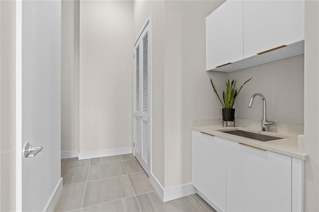 corridor featuring light tile patterned flooring and sink