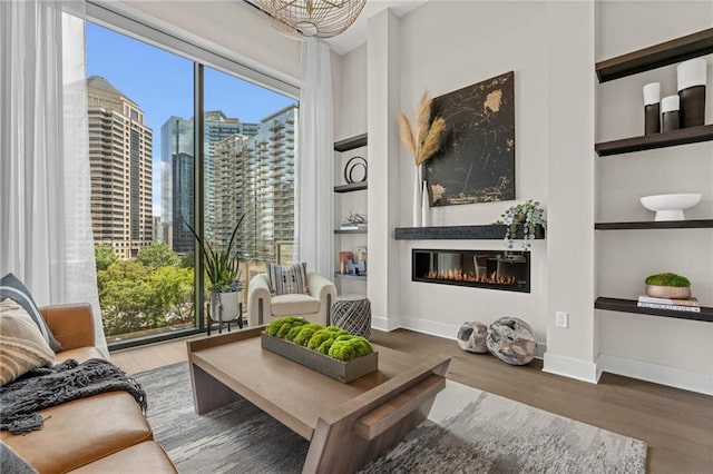 living area featuring hardwood / wood-style flooring and built in features