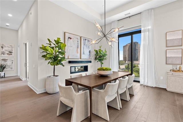 dining area featuring hardwood / wood-style flooring and a chandelier