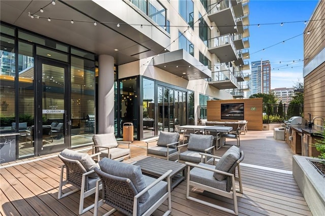 wooden terrace featuring a grill