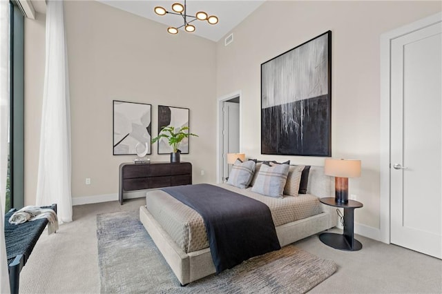 carpeted bedroom with an inviting chandelier