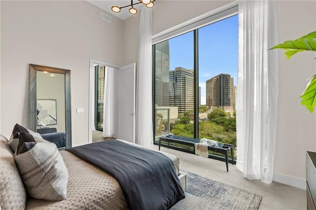 carpeted bedroom featuring multiple windows and a towering ceiling