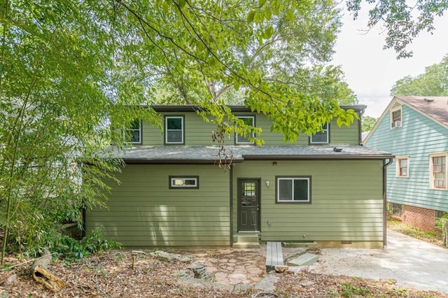 back of house with entry steps and a shingled roof