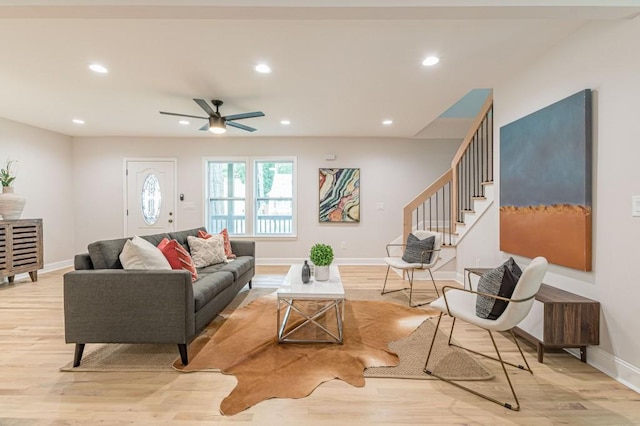 living room with baseboards, stairway, recessed lighting, and light wood-style floors