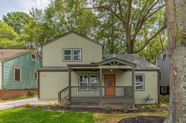 view of front of property featuring a porch and a shingled roof