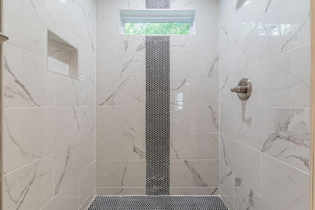 full bathroom with a tile shower