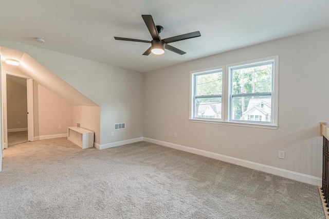 additional living space with ceiling fan, carpet flooring, visible vents, and baseboards