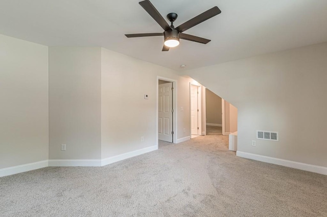 unfurnished room with a ceiling fan, carpet flooring, visible vents, and baseboards