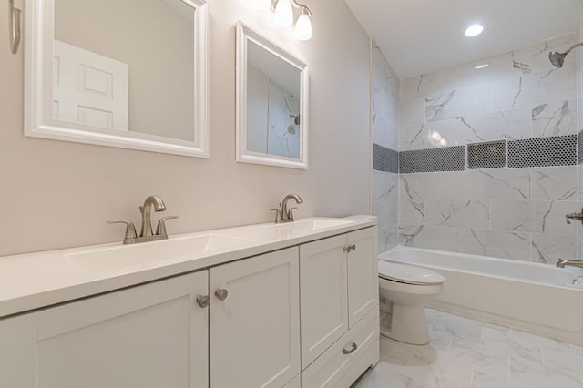 bathroom with double vanity, bathing tub / shower combination, toilet, marble finish floor, and a sink