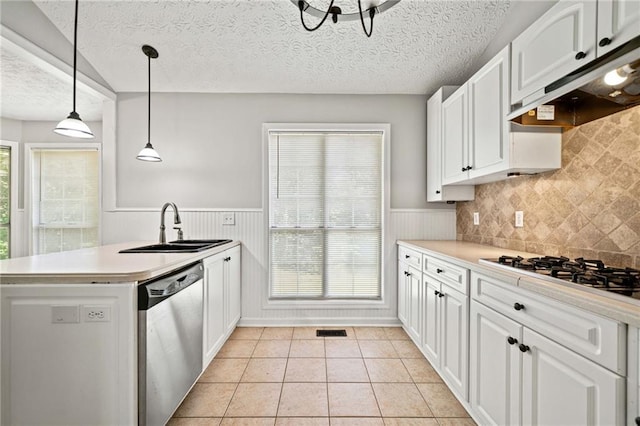 94 Park Ave W, Dallas, GA 30157 - kitchen featuring stainless steel appliances, under cabinet range hood, a peninsula, white cabinets, and a wainscoted wall
