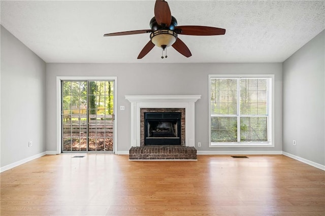 94 Park Ave W, Dallas, GA 30157 - unfurnished living room with wood finished floors, a fireplace, and ceiling fan