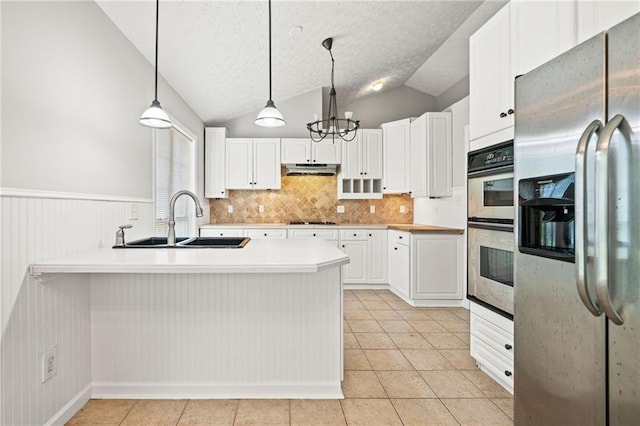 94 Park Ave W, Dallas, GA 30157 - kitchen with appliances with stainless steel finishes, light countertops, light tile patterned flooring, white cabinets, and vaulted ceiling