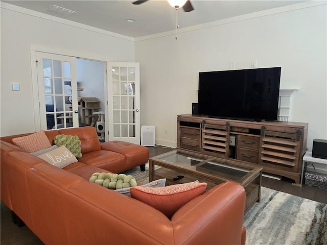 living room with ceiling fan, wood finished floors, baseboards, french doors, and ornamental molding