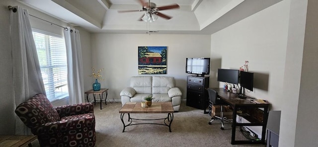 carpeted living room featuring ceiling fan and a raised ceiling