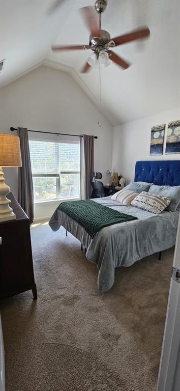 carpeted bedroom featuring lofted ceiling and ceiling fan