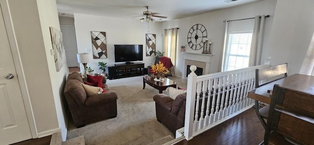 living room with ceiling fan and dark wood-type flooring