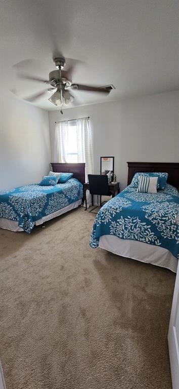 bedroom featuring ceiling fan and carpet floors