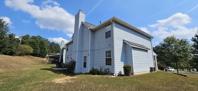 view of home's exterior featuring a yard and central AC unit