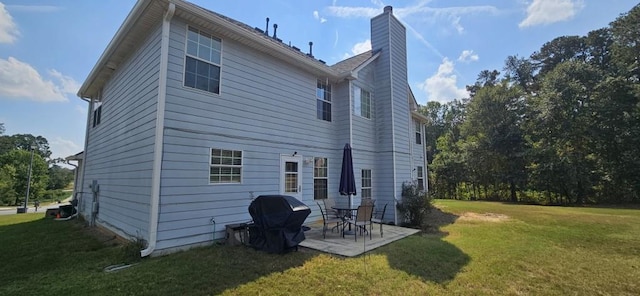 back of property featuring a lawn and a patio area