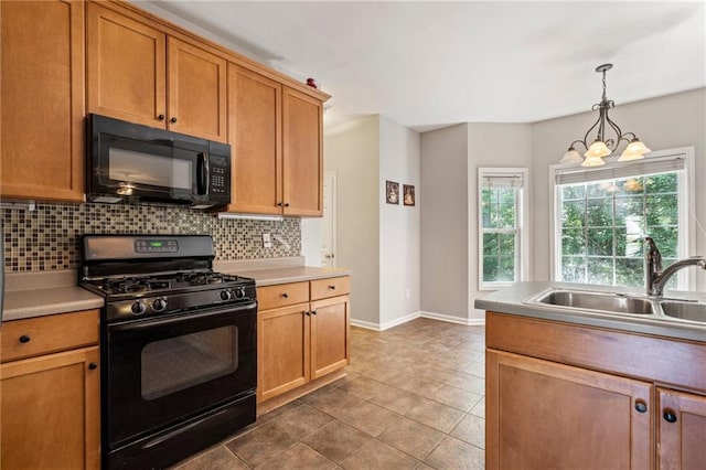 kitchen with tile patterned flooring, sink, hanging light fixtures, decorative backsplash, and black appliances