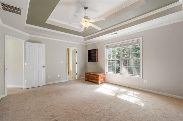 unfurnished bedroom featuring a raised ceiling, light carpet, and ceiling fan