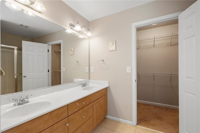 bathroom featuring vanity, tile patterned floors, and an enclosed shower