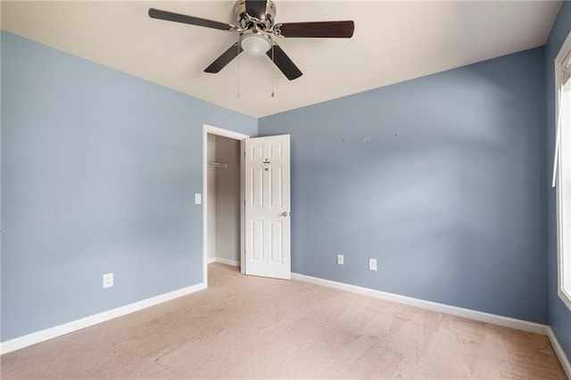 spare room featuring ceiling fan and light colored carpet