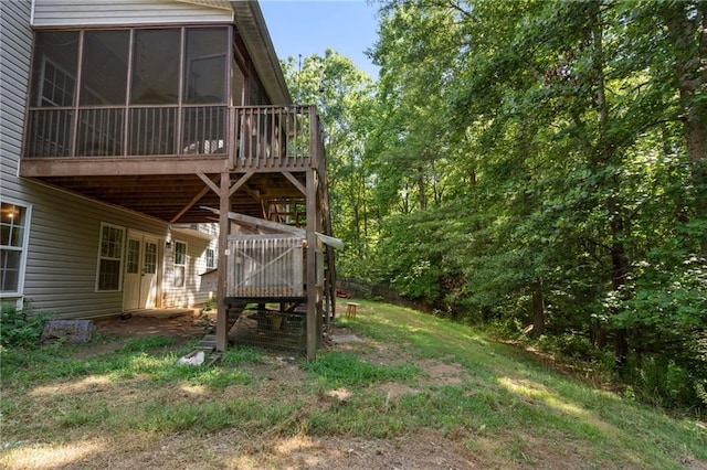 view of yard with a sunroom and a wooden deck