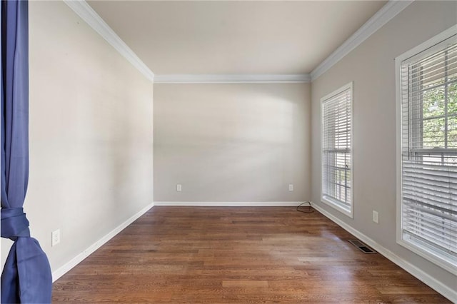 unfurnished room featuring dark wood-type flooring and crown molding