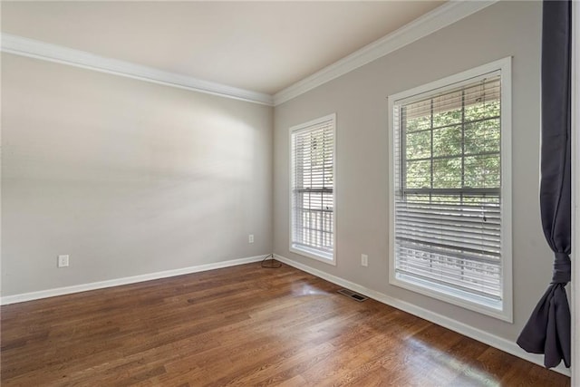 spare room with crown molding and dark hardwood / wood-style flooring