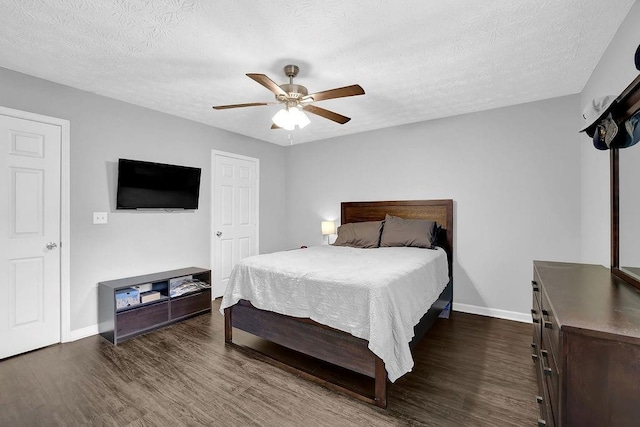 5461 Forest Path Ct, Stone Mountain, GA 30088 - bedroom featuring dark wood finished floors, baseboards, a textured ceiling, and ceiling fan