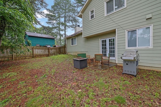 5461 Forest Path Ct, Stone Mountain, GA 30088 - rear view of house with a chimney, a patio area, and french doors