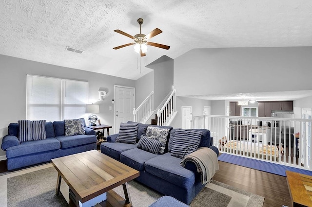 5461 Forest Path Ct, Stone Mountain, GA 30088 - living room featuring ceiling fan, vaulted ceiling, a textured ceiling, wood finished floors, and stairs