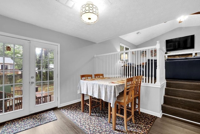 5461 Forest Path Ct, Stone Mountain, GA 30088 - dining area with french doors, wood finished floors, a textured ceiling, lofted ceiling, and baseboards